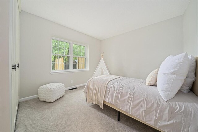 bedroom with baseboards and carpet floors