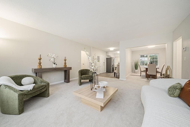 living room with light carpet and baseboards
