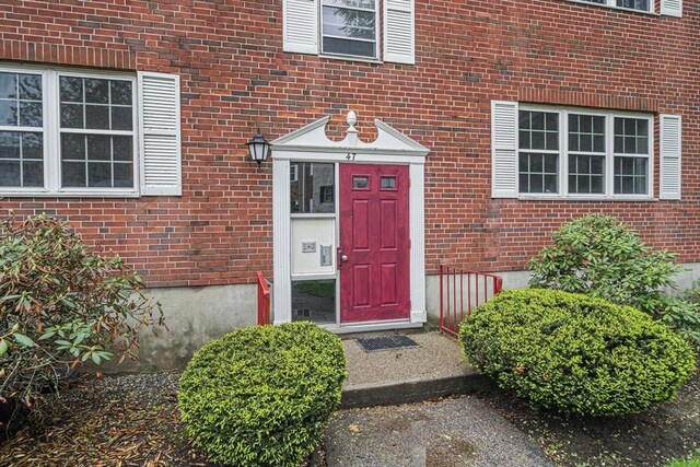 property entrance with brick siding