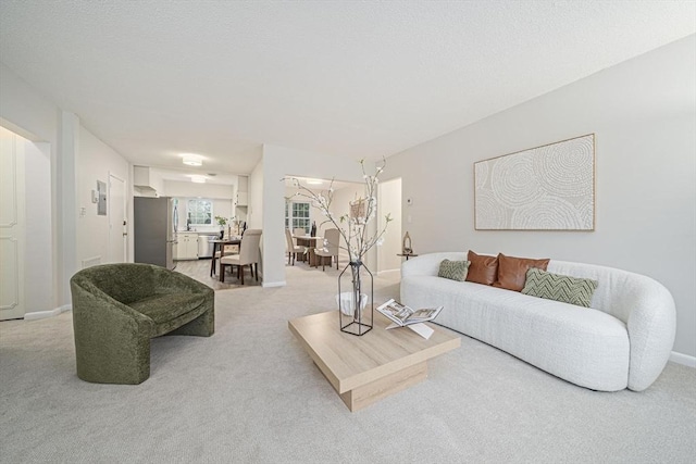 living room featuring light carpet and baseboards