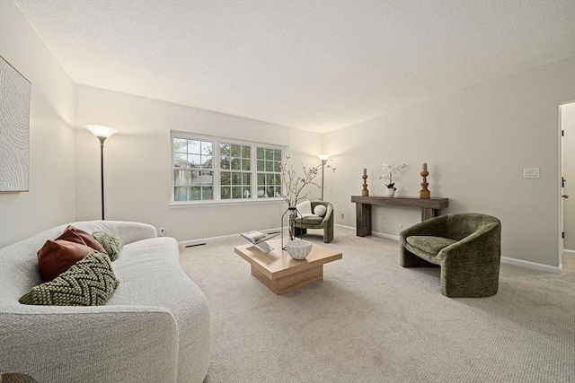 carpeted living room with baseboards and a textured ceiling