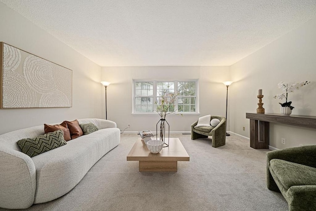 carpeted living room with baseboards and a textured ceiling