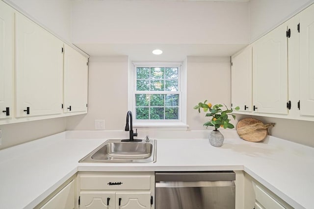 kitchen featuring dishwasher, a sink, white cabinetry, light countertops, and recessed lighting