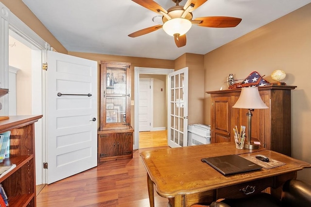 office featuring wood finished floors and a ceiling fan