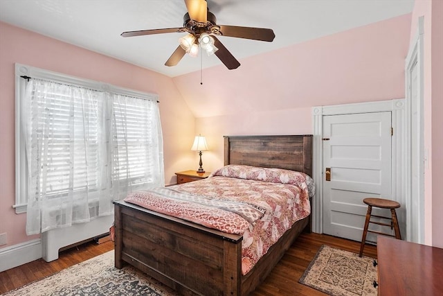 bedroom with wood finished floors, a ceiling fan, and vaulted ceiling