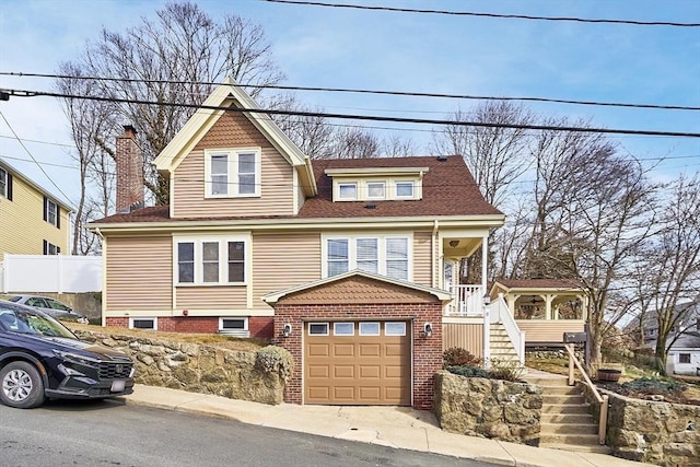 view of front of home with stairway, a porch, a chimney, a shingled roof, and a garage