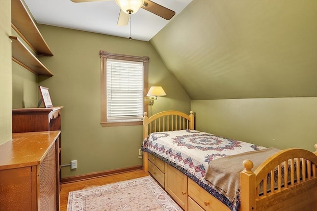 bedroom featuring vaulted ceiling, a ceiling fan, light wood-type flooring, and baseboards