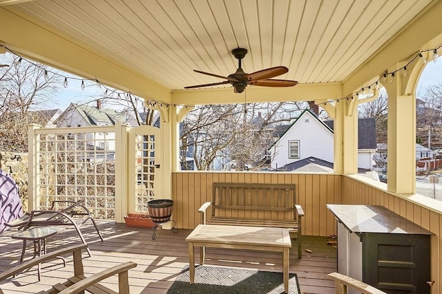 wooden terrace featuring ceiling fan