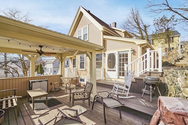 deck featuring area for grilling and ceiling fan