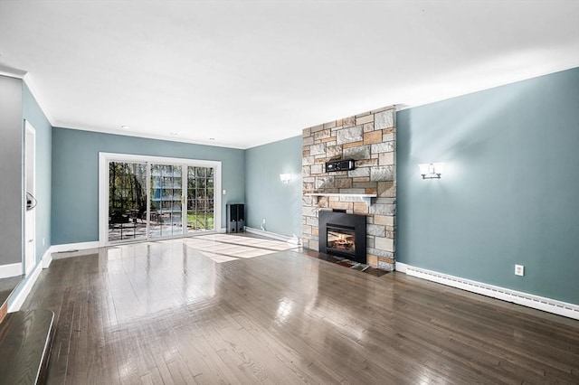 unfurnished living room with crown molding, baseboards, wood finished floors, and a fireplace