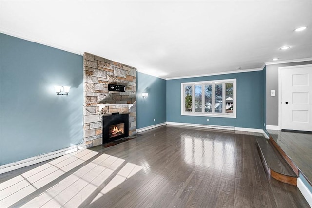 unfurnished living room with crown molding, baseboards, a baseboard heating unit, and a stone fireplace