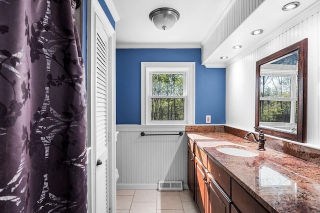 full bath with vanity, tile patterned floors, a wainscoted wall, visible vents, and ornamental molding