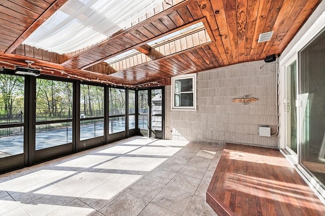 unfurnished sunroom featuring a skylight and visible vents