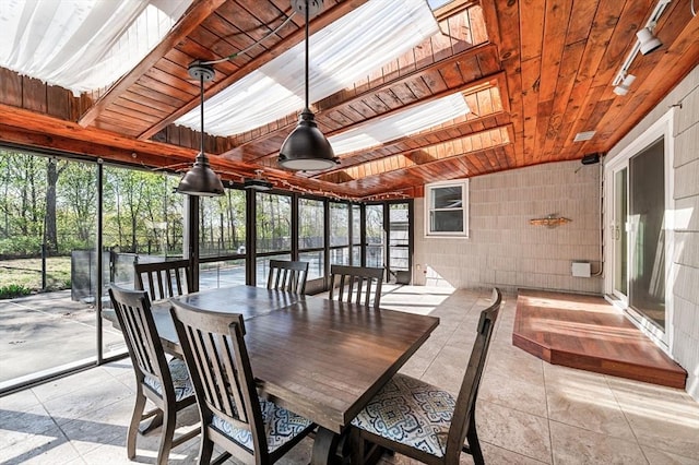 unfurnished sunroom with a wealth of natural light and a skylight