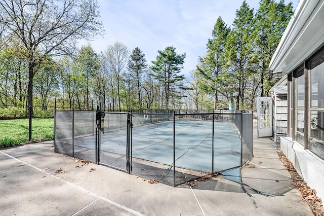 view of tennis court featuring fence