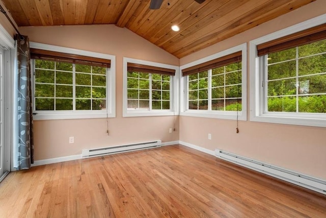 unfurnished sunroom with a baseboard heating unit, vaulted ceiling, and healthy amount of natural light
