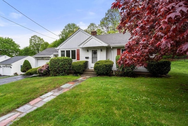 bungalow featuring a chimney, a front lawn, and an attached garage