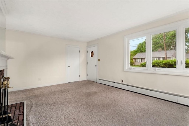 unfurnished living room with a baseboard radiator, carpet flooring, and a fireplace with raised hearth