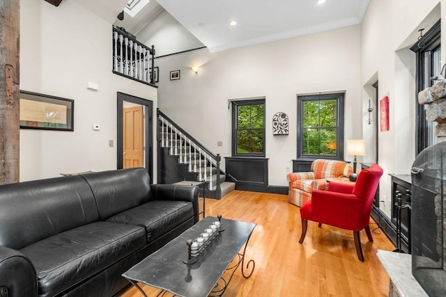 994 Centre St, Boston, MA 02130 - living room with light wood-style flooring, a towering ceiling, stairs, recessed lighting, and ornamental molding