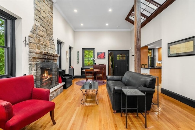 994 Centre St, Boston, MA 02130 - living room featuring plenty of natural light, a fireplace, ornamental molding, wood finished floors, and a high ceiling