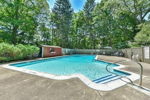 994 Centre St, Boston, MA 02130 - community pool featuring view of scattered trees, a patio area, and an outbuilding