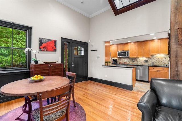 994 Centre St, Boston, MA 02130 - dining space with a towering ceiling, ornamental molding, light wood-style flooring, and baseboards