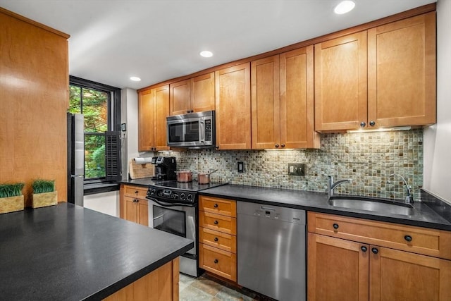994 Centre St, Boston, MA 02130 - kitchen with appliances with stainless steel finishes, a sink, dark countertops, decorative backsplash, and recessed lighting