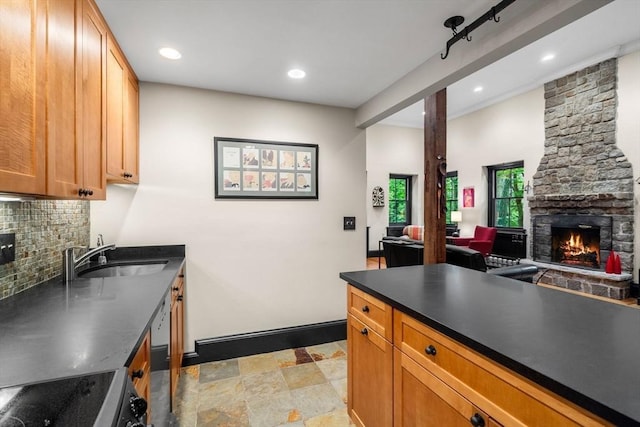 994 Centre St, Boston, MA 02130 - kitchen featuring a sink, a fireplace, stove, tasteful backsplash, and stone finish floors