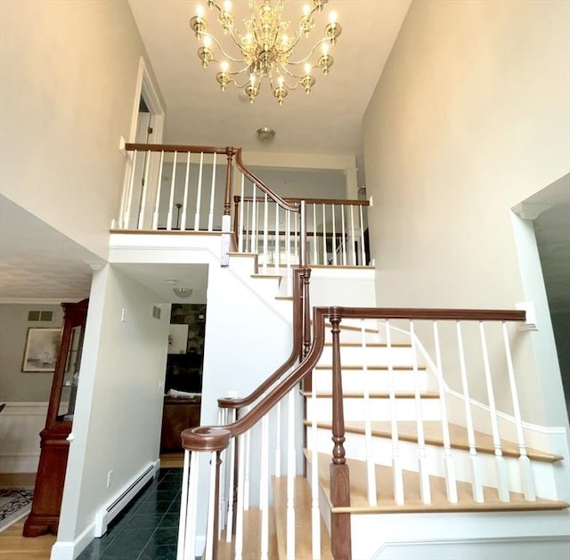 40 King Philip Dr, Rehoboth, MA 02769 - stairway with baseboard heating and a chandelier