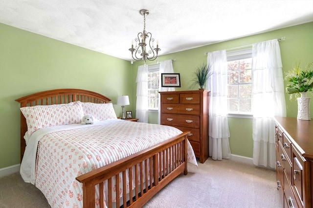 40 King Philip Dr, Rehoboth, MA 02769 - bedroom featuring light colored carpet, a chandelier, and baseboards