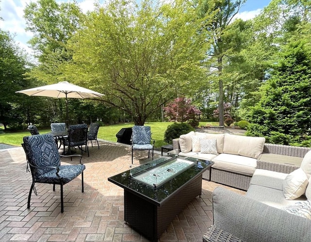 40 King Philip Dr, Rehoboth, MA 02769 - view of patio with an outdoor living space with a fire pit and view of wooded area