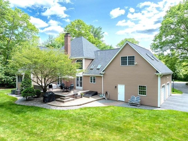 40 King Philip Dr, Rehoboth, MA 02769 - rear view of house featuring a patio area, a yard, asphalt driveway, and a chimney