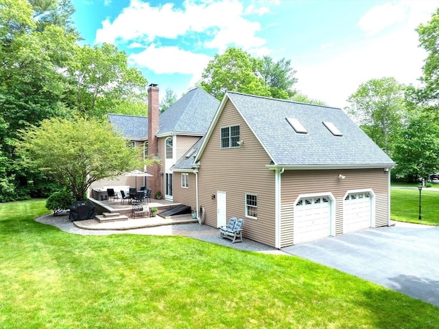 40 King Philip Dr, Rehoboth, MA 02769 - view of property exterior with a yard, a patio, a garage, a shingled roof, and driveway