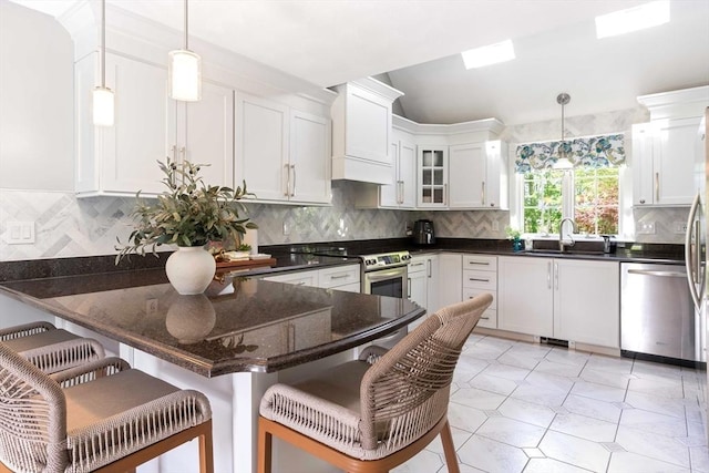 40 King Philip Dr, Rehoboth, MA 02769 - kitchen featuring appliances with stainless steel finishes, a sink, white cabinets, a peninsula, and custom exhaust hood
