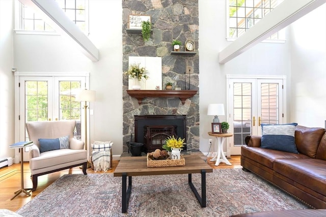 40 King Philip Dr, Rehoboth, MA 02769 - living room with a towering ceiling, french doors, a fireplace, and plenty of natural light