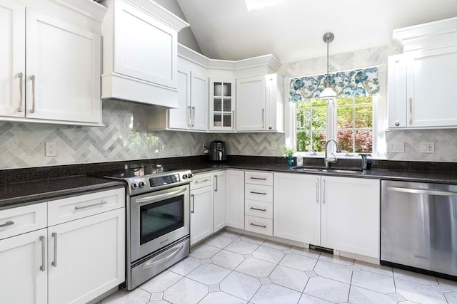 40 King Philip Dr, Rehoboth, MA 02769 - kitchen featuring appliances with stainless steel finishes, a sink, lofted ceiling, backsplash, and white cabinetry