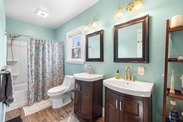 full bathroom with hardwood / wood-style flooring, vanity, toilet, and shower / bath combo with shower curtain