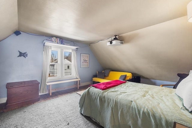 bedroom featuring hardwood / wood-style flooring and vaulted ceiling