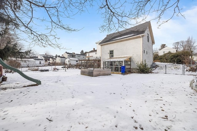 view of snow covered rear of property