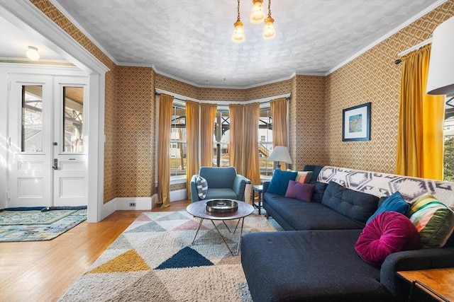 living room with crown molding, a textured ceiling, and light hardwood / wood-style floors