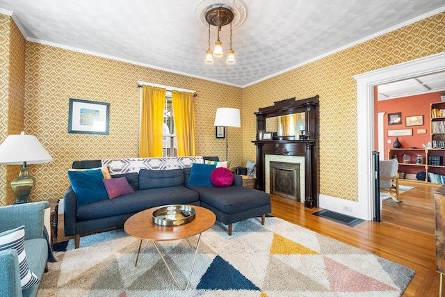 living room with hardwood / wood-style floors and ornamental molding