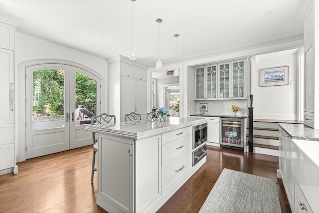 5 Stratford Rd, Winchester, MA 01890 - kitchen featuring wine cooler, dark wood finished floors, plenty of natural light, and a warming drawer