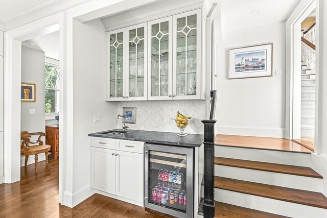 5 Stratford Rd, Winchester, MA 01890 - indoor wet bar with wine cooler, stairs, dark wood finished floors, backsplash, and baseboards