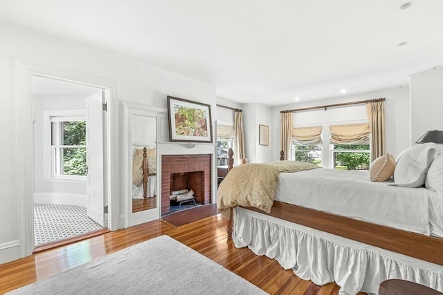 5 Stratford Rd, Winchester, MA 01890 - bedroom featuring multiple windows, wood finished floors, a brick fireplace, and recessed lighting