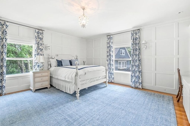 5 Stratford Rd, Winchester, MA 01890 - bedroom with a decorative wall, light wood-type flooring, and a chandelier