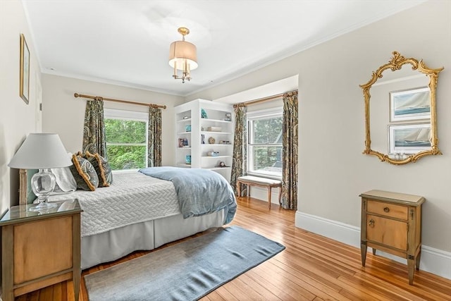 5 Stratford Rd, Winchester, MA 01890 - bedroom with multiple windows, hardwood / wood-style flooring, baseboards, and crown molding
