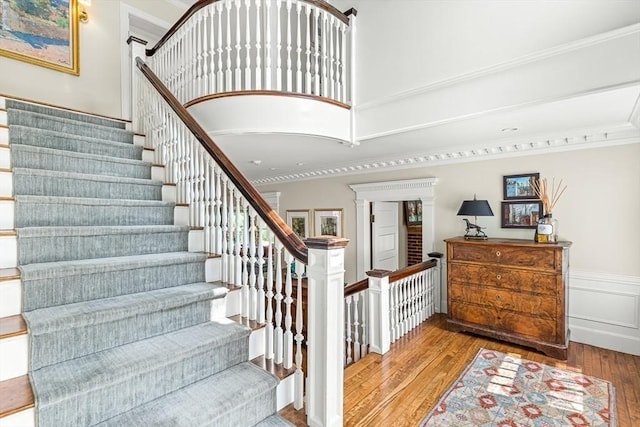 5 Stratford Rd, Winchester, MA 01890 - stairway featuring hardwood / wood-style flooring, crown molding, and a wainscoted wall