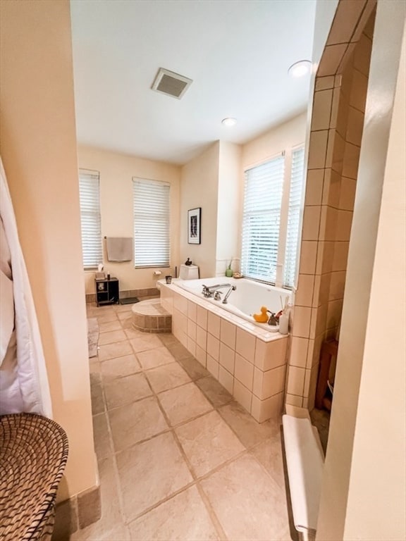 bathroom featuring tiled bath and tile patterned floors