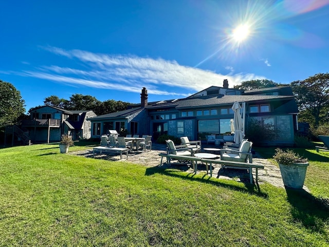 back of property with a patio, outdoor lounge area, and a yard