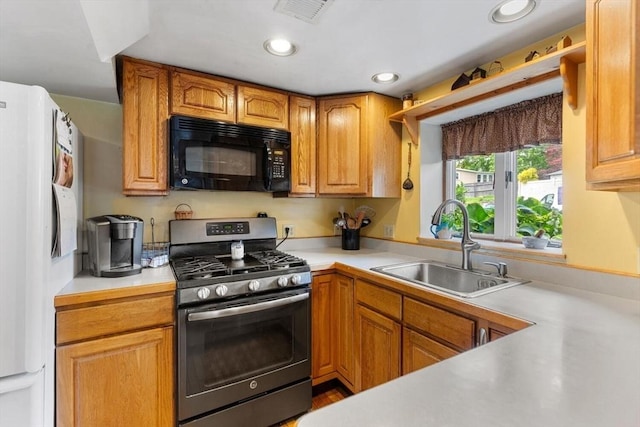 12 Clarner Rd, Lynn, MA 01904 - kitchen featuring black microwave, stainless steel gas range oven, freestanding refrigerator, light countertops, and recessed lighting